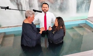 Roberto Velazco (left) and his wife Otelina (right) of Tapachula in Chiapas, are prayed for before they are baptized June 24, 2023. They received a copy of “The Great Controversy” book back in March, and accepted an invitation to visit an Adventist Church.  Bible studies followed. They were among the more than 9,000 persons who joined the church in the Chiapas Mexican Union since evangelism efforts began this year. [Photo: Chiapas Mexican Union]